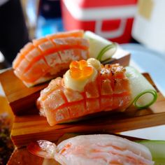 two sushi rolls on a plate with cucumbers and celery