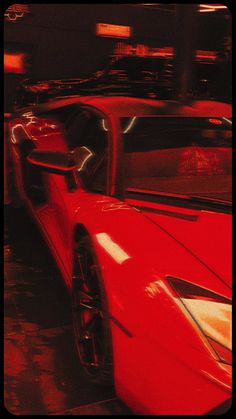 a red sports car parked in front of a building