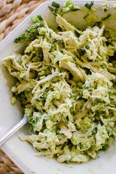 a white bowl filled with broccoli on top of a table