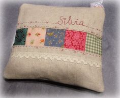 a small pillow that has some fabric on the front and sides with name written on it