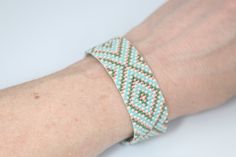 Get your boho vibes in this cream, sage green, coral, and aqua adjustable cuff style bracelet. Tiny delica seed beads sewn an intricate boho tribal pattern. Southwest boho chic at its best!Materials DelicasLead & Nickel Free Metal Slider Clasp with an Adjustable Lobster Claw & Chain Closure SIze 3/4 of an inch wide Adjustable from 6.5-8 inches long Green Bohemian Woven Beaded Bracelets, Green Bohemian Woven Bracelets, Green Woven Beaded Bohemian Bracelet, Bohemian Green Woven Beaded Bracelets, Adjustable Bohemian Cream Beaded Bracelets, Adjustable Cream Bohemian Beaded Bracelets, Coral And Aqua, Southwest Boho, Jewelry Hippie