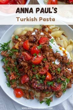 an image of a plate of food with pasta and meat on it, including tomatoes