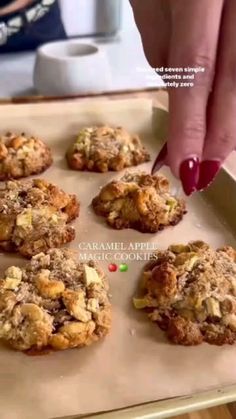 a person picking up some cookies from a pan