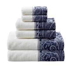 four towels stacked on top of each other in blue and white paisley print, with one folded