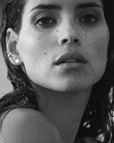 black and white photograph of a woman with freckles on her hair looking at the camera