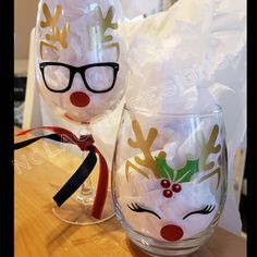 two wine glasses decorated with christmas decorations