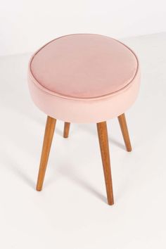 a pink stool with wooden legs on a white background