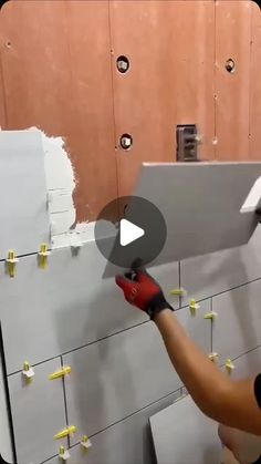 a man is working on a wall with yellow post it notes