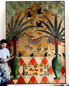 a man standing in front of a painting with vases and palm trees on it