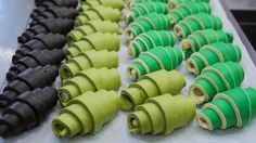 many green and black rolled up objects on a table