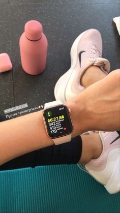 a woman is sitting on the floor with her apple watch