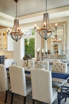 a dining room table with chairs and chandelier