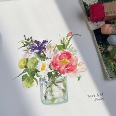 watercolor painting of flowers in a vase on paper next to colored crayons