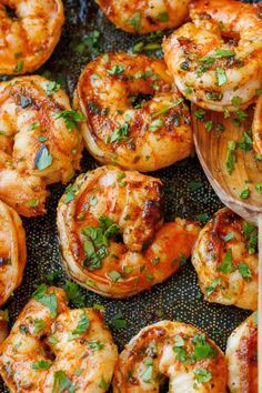 grilled shrimp with parsley on top in a skillet, ready to be served