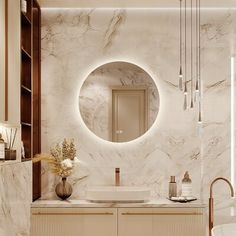 a bathroom with marble walls and flooring has a round mirror on the wall above the sink