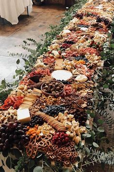 a long table filled with lots of different types of food on top of each other