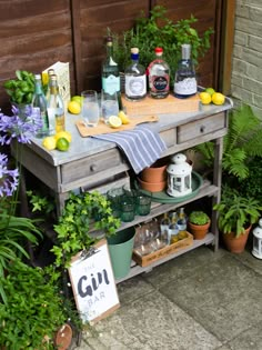 an outdoor bar with bottles and glasses on it