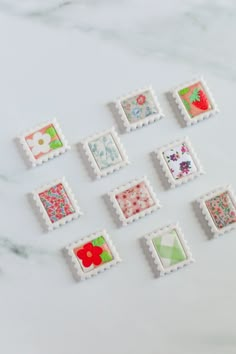 six stamps with different designs on them sitting on a table