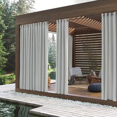 an outdoor living area with sliding glass doors and wooden decking next to the pool