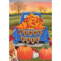 a blue truck filled with pumpkins sitting on top of a field