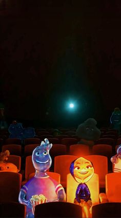 some cartoon characters are sitting in an empty theater seat and watching the show at night