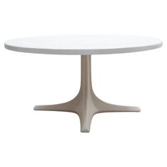 a white table with an oval top and metal base, on a white background in the shape of a flower