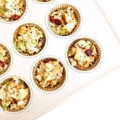 a muffin tin filled with different types of food