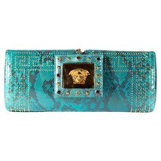 This stunning, convertible Versace clutch in dyed blue python is intricately studded to form a classic Greek key motif along the borders. Front and center, a mirrored gold medusa plaque accents the snap closure. Donatella designed this convertible clutch for the Gianni Versace Spring/Summer 2000 collection and prominently featured it in that season's runway and ad campaign with Amber Valletta. British Vogue featured this blue python variation in an editorial spread by Raymond Meier. This beautif Versace Turquoise Bag, Luxury Blue Rectangular Clutch, Luxury Clutch With Gold-tone Hardware, Versace Clutch, Raymond Meier, Blue Convertible, Blue Python, Amber Valletta, Versace Blue