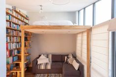 a living room filled with furniture and bookshelves