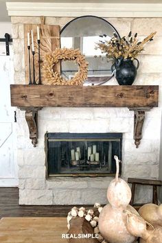 a living room filled with furniture and a fire place in front of a mantle topped with flowers