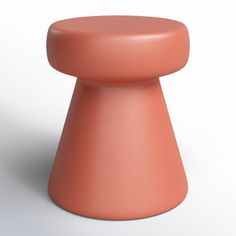 an orange stool sitting on top of a white floor