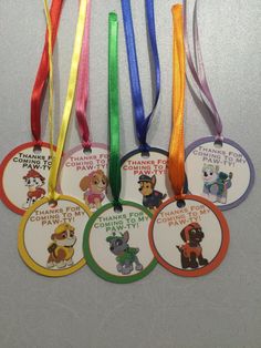 four different colored tags with cartoon characters on them, one is for children's birthday