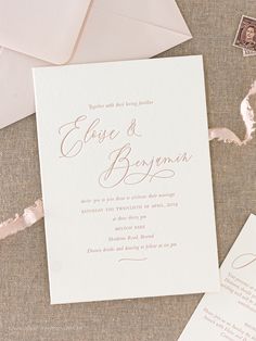 the wedding stationery is laid out on top of an envelope