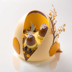 an egg decorated with flowers and chocolates