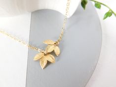 Delicate Leaf Necklace with beautiful detail. Available in silver or gold features two three leaf pendants connected asymmetrically. Dainty and Feminine, an everyday piece that you won't want to take off. Features: * Silver Plated Leaves Pendants * Sterling Silver Chain *Sterling Silver Spring Clasp *Gold Plated Leaves Pendants *14k Gold Filled Chain * Gold Filled Spring Ring Clasp Fast shipping - Shipped in 1 to 3 business days. Comes in a Gift Box, Ready for gift giving. Perfect for bridesmaid Yellow Gold Charm Necklaces For Wedding, Gold Delicate Chain Bridal Necklace For Bridesmaid Gift, Gold Bridal Necklace With Delicate Chain For Bridesmaid Gift, Dainty Gold Bridal Necklace For Bridesmaid Gift, Delicate Gold Bridal Necklace For Anniversary, Simple Wedding Necklace, Wedding Necklace Simple, Leaf Necklace Gold, Wedding Jewelry Simple