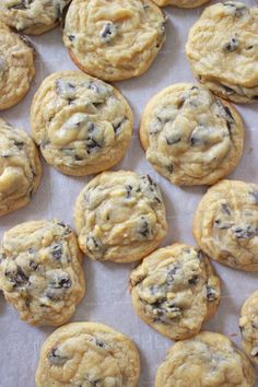 chocolate chip cookies sitting on top of a baking sheet