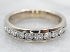 a close up view of a wedding ring with diamonds