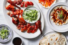 an assortment of food on plates and bowls