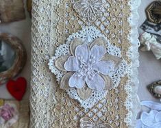 a close up of a piece of cloth with flowers on it and other items in the background