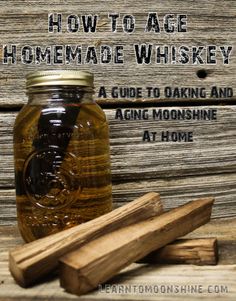 a bottle of homemade whiskey next to two cinnamon sticks and a wooden stick with the words how to age homemade whiskey