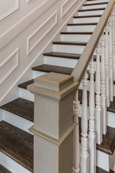 the stairs are painted white and have wooden balconies