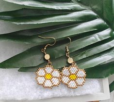 ☀️These hand beaded Daisy Earrings were made with colorful seed beads some of which are 24 Karat gold. 🌼 Perfect for the summer or on vacation! ☀️ LOCAL PICK UP NOTE: THIS IS AVAILABLE FOR LOCAL PICK UP!  JUST SEND US A MESSAGE BEFORE YOU BUY IF YOU ARE LOCAL! CUSTOM ORDERS Would you like a custom order? Something similar but in a different size or color? Contact me and we can figure it out together - I love creating custom items so please don't hesitate to ask. Please allow 2-3 weeks from the date you submit payment for your custom order to be created and shipped. We will keep in contact through email so you can see the progress of your custom item. If your item is already made, allow 1-3 days for delivery. Visit the shop here: https://www.etsy.com/shop/martiancreations?ref=hdr_shop_menu Beaded Flower Earrings For Summer, Summer Gold Beaded Earrings, Summer White Flower Earrings With Colorful Beads, Handmade White Beaded Flower-shaped Earrings, Handmade White Beaded Flower Earrings, Flower Shaped Earrings With Colorful Beads For Beach, Flower-shaped Earrings With Colorful Beads For Beach, Beaded Daisy Earrings, Beaded Flower Earrings