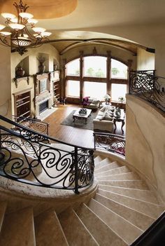 a living room filled with furniture and a spiral staircase