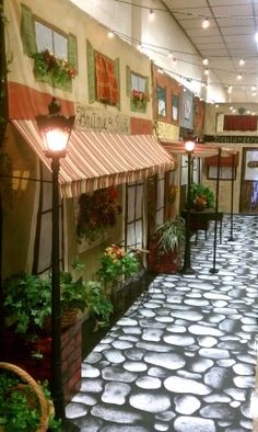 the inside of a building with many potted plants