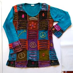 a shirt made out of old clothes with peace signs on the front and side panels