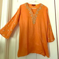 Orange Silk Kurti With Detailed Hand-Sewn Embroidery Around Neckline And On Bell Sleeves. Size L But Can Be Worn By Smaller Sizes As Well. Orange Embroidered V-neck Top, Embroidered Orange V-neck Tops, Spring Long Sleeve Kurta With Gota Work, Orange Long Sleeve Tops For Festive Season, Orange Embroidered Cotton Blouse, Traditional Embellished Spring Kurta, Long Sleeve Embellished Festive Tunic, Festive Embellished Long Sleeve Tunic, Festive Long Sleeve Embellished Tunic