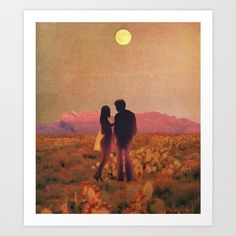 two people standing in the middle of a field under a full moon with mountains in the background