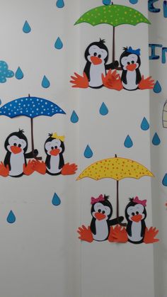 the penguins are holding umbrellas in the rain