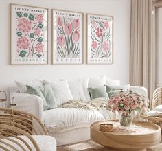 a living room with wicker furniture and pink flowers on the wall hanging above it