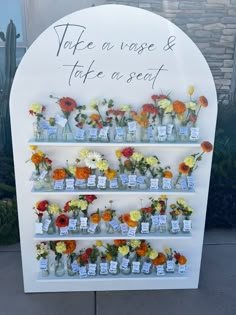 there are many vases and flowers on the wall with words written on them that read, take a vage & take a seat